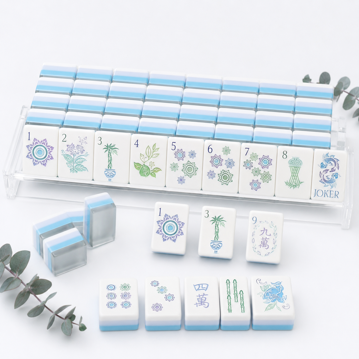 Set of white and blue mahjong tiles with decorative designs on a light gray background.
