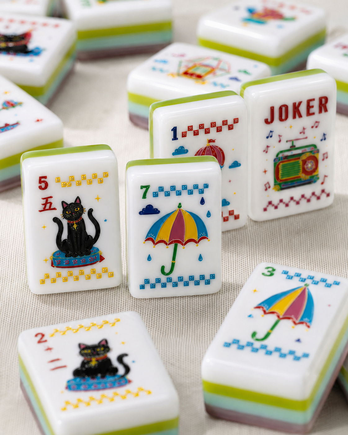 Colorful American mahjong tile close-up with black cat, umbrella and retro radio artwork