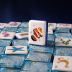 Close-up of a clownfish mahjong tile standing among shimmering blue marbled ocean-themed tiles.