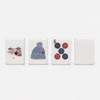 White knitting-themed mahjong tiles featuring cats, a blue knit hat, colorful buttons, and a plain white tile back