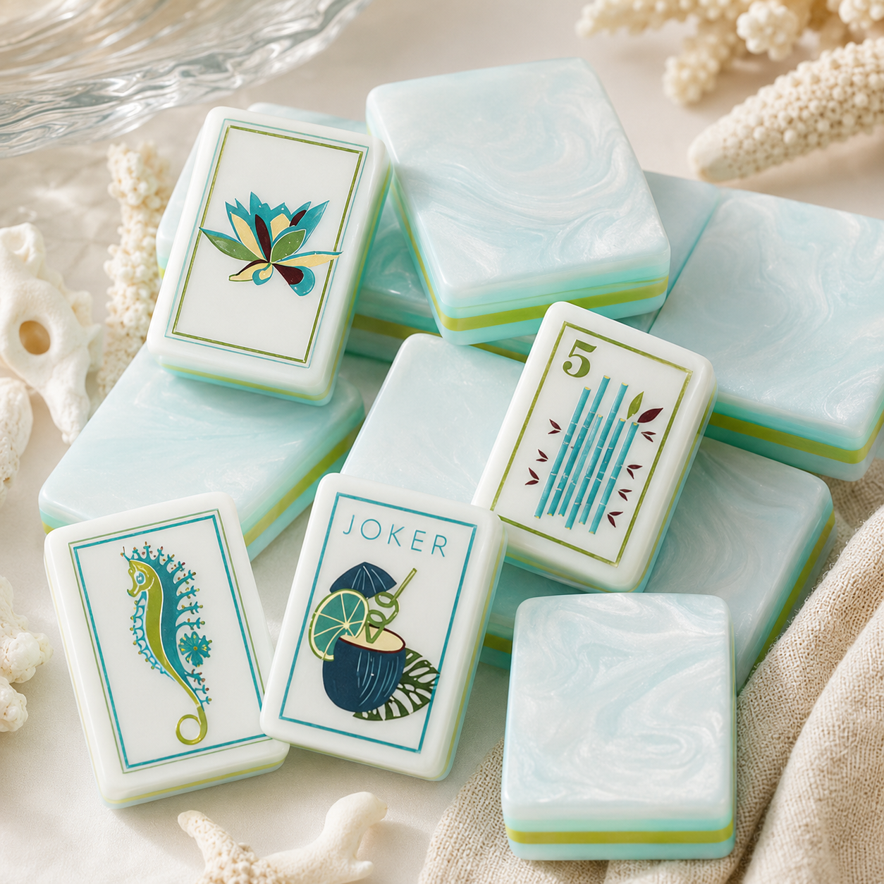 Close-up of glossy aqua and white mahjong tiles with tropical Joker artwork