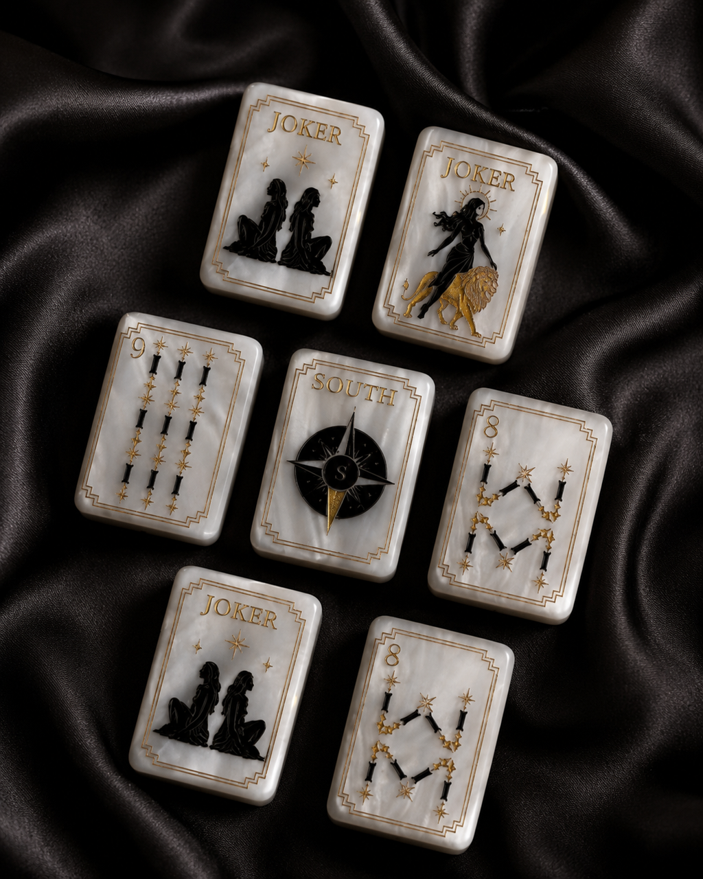 Celestial Pearl Mahjong tiles scattered across flowing black satin fabric