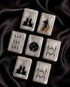 Celestial Pearl Mahjong tiles scattered across flowing black satin fabric