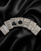 Luxury American Mahjong tiles arranged in a fan shape on black satin