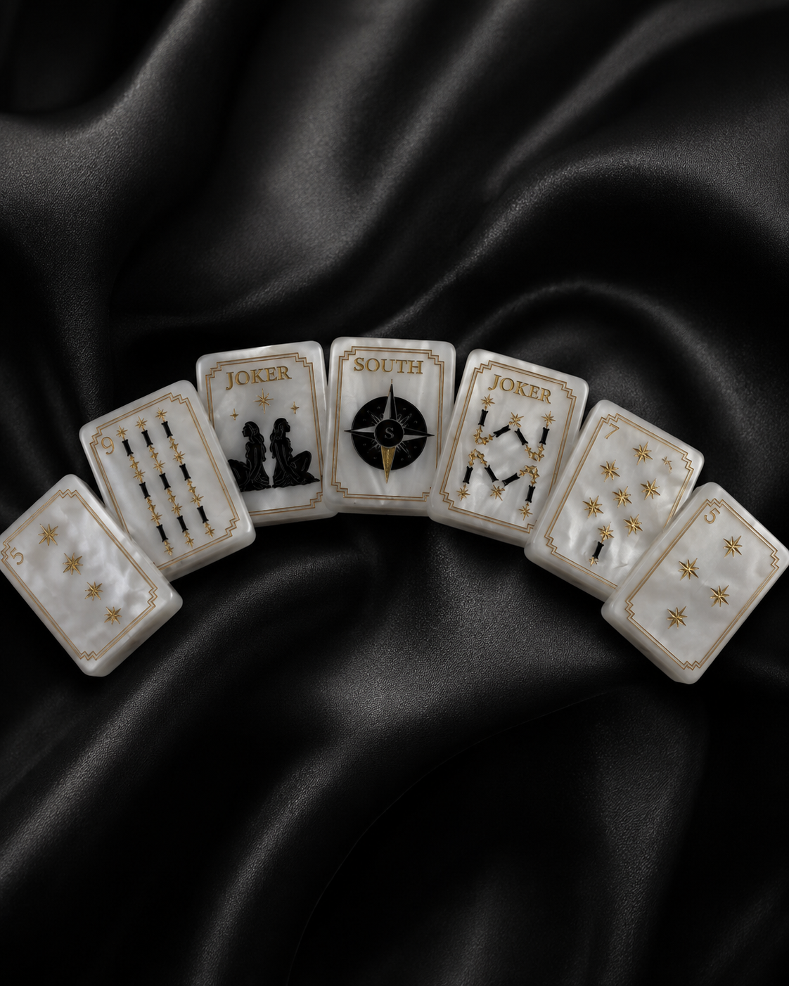 Luxury American Mahjong tiles arranged in a fan shape on black satin