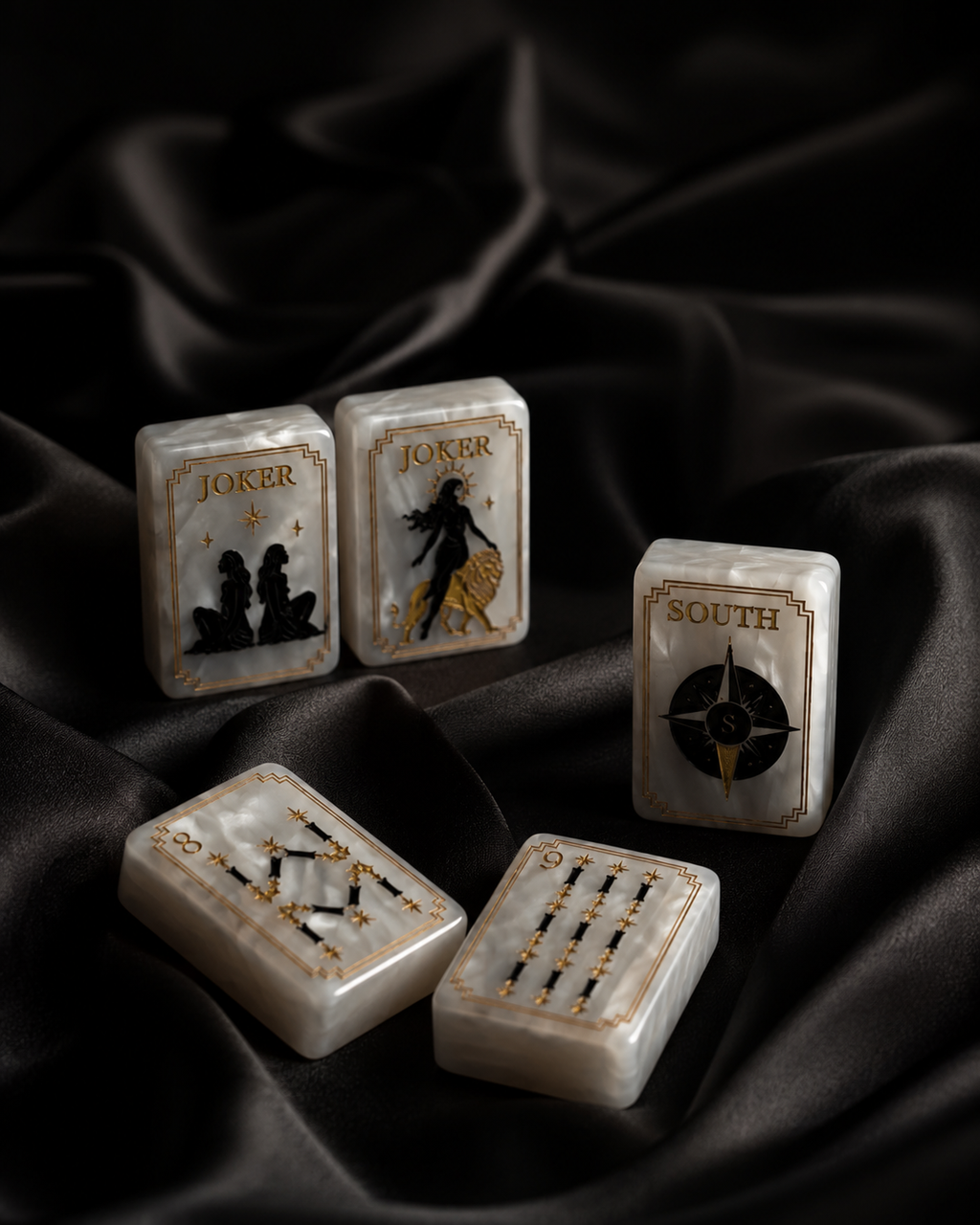 Celestial Mahjong tiles displayed upright and flat on elegant black silk