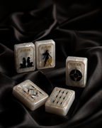Celestial Mahjong tiles displayed upright and flat on elegant black silk