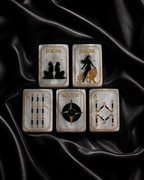 Pearl white American Mahjong tiles arranged neatly on black satin with gold detailing