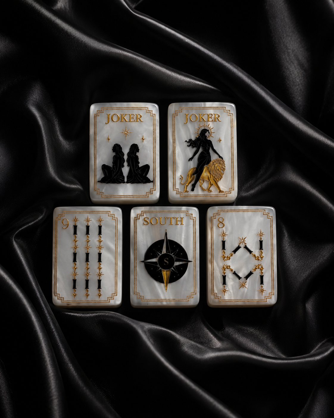Pearl white American Mahjong tiles arranged neatly on black satin with gold detailing
