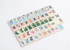 Complete colorful Tropical Seaside American Mahjong tile set arranged with matching green and blue mahjong mat
