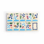 Four tropical American Mahjong tiles featuring toucan, green leaf number tile, joker tile, and blue checker back design