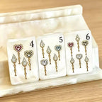 Close-up of Jewel Pearl Mahjong tiles with gemstone-inspired floral artwork