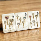 Luxury acrylic Mahjong tiles with pearl finish, gold details, and colorful jewel accents