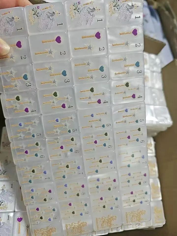 Close-up of Jewel Pearl Mahjong tiles with gemstone-inspired floral artwork